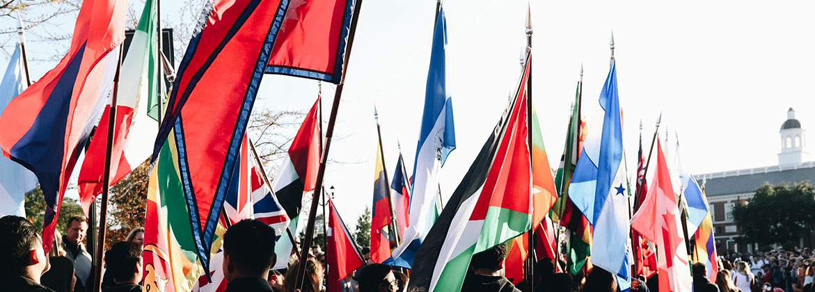 International Students hold their flags during the homecoming parade