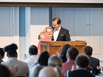 Susie Cassel receiving the award for Staff Member of the Year from DBU President Dr. Adam C. Wright in the Hillcrest Great Hall on the DBU Campus