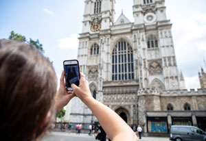 picture of a woman taking a picture of a cathedral building